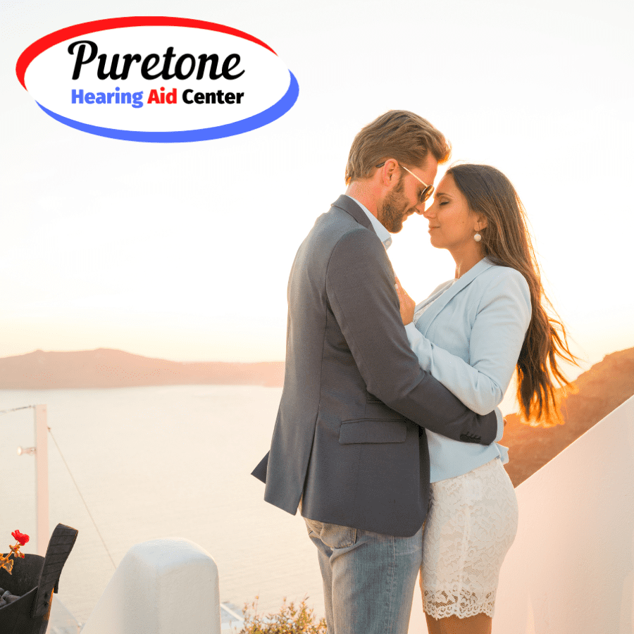 Couple hugging in front of a sunset and the company logo.